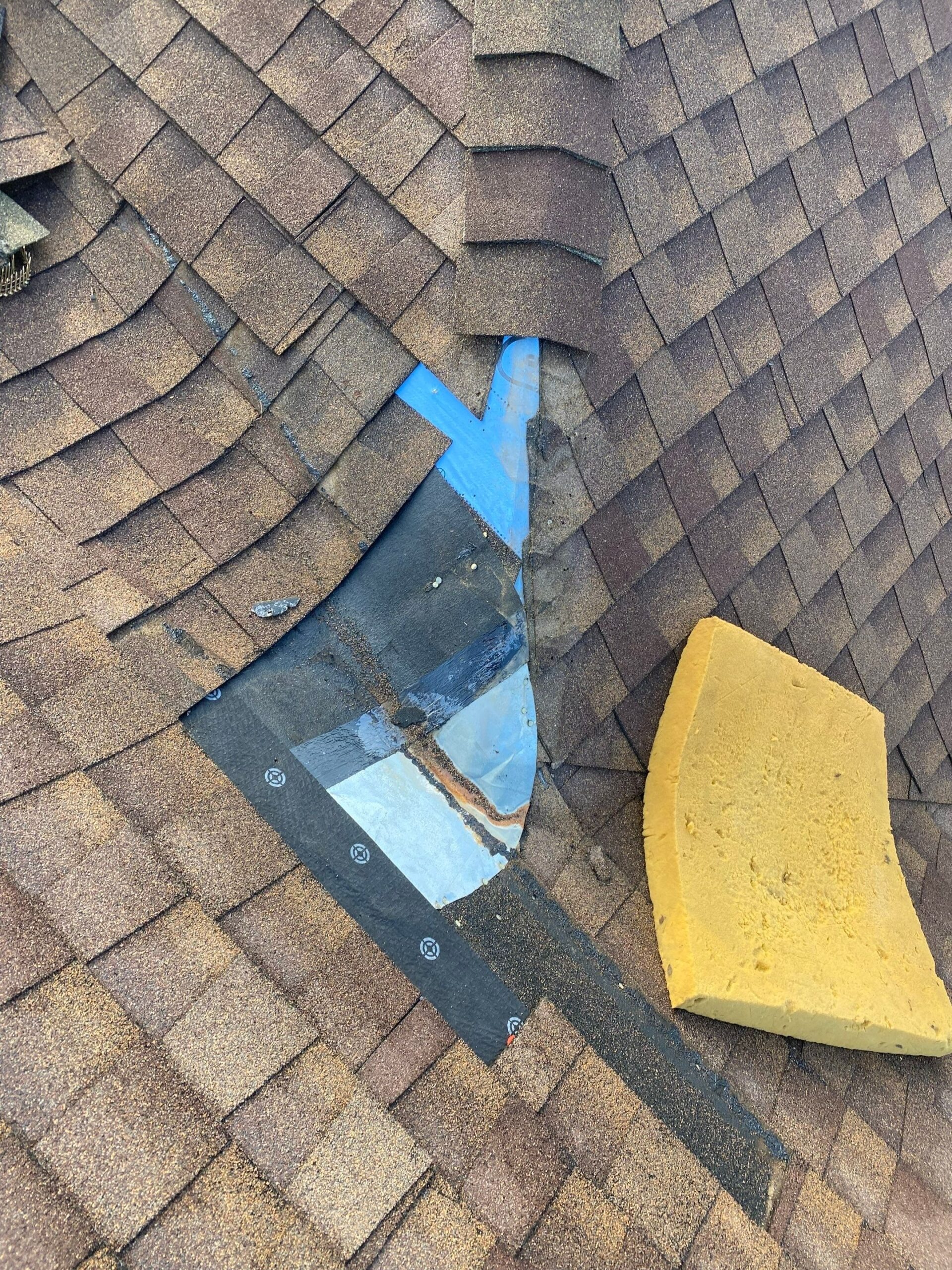 During roof repair in Anna as crew installs new valley flashing over damaged section