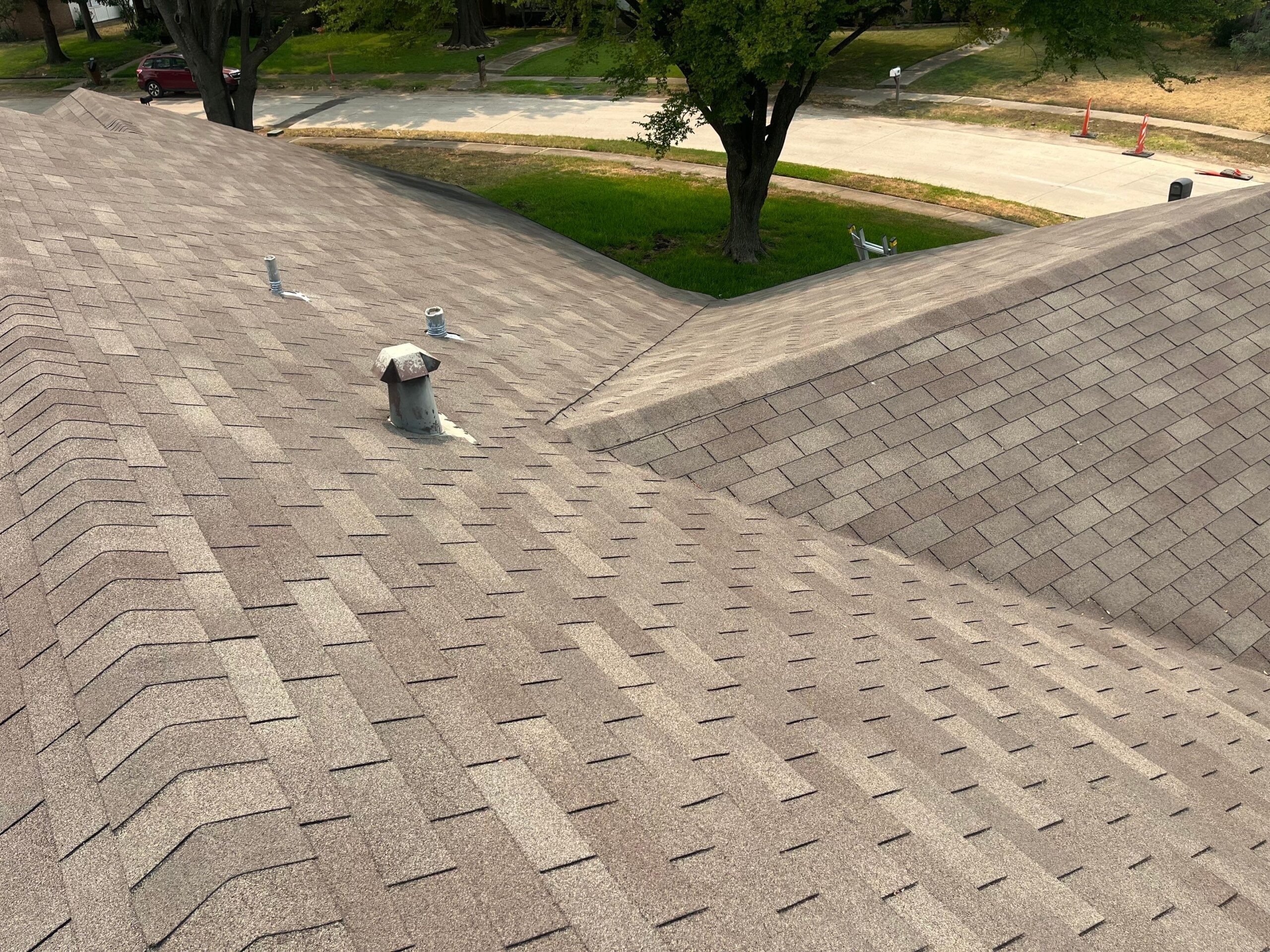 During: crew documents granule loss spread across shingle field on Plano roof