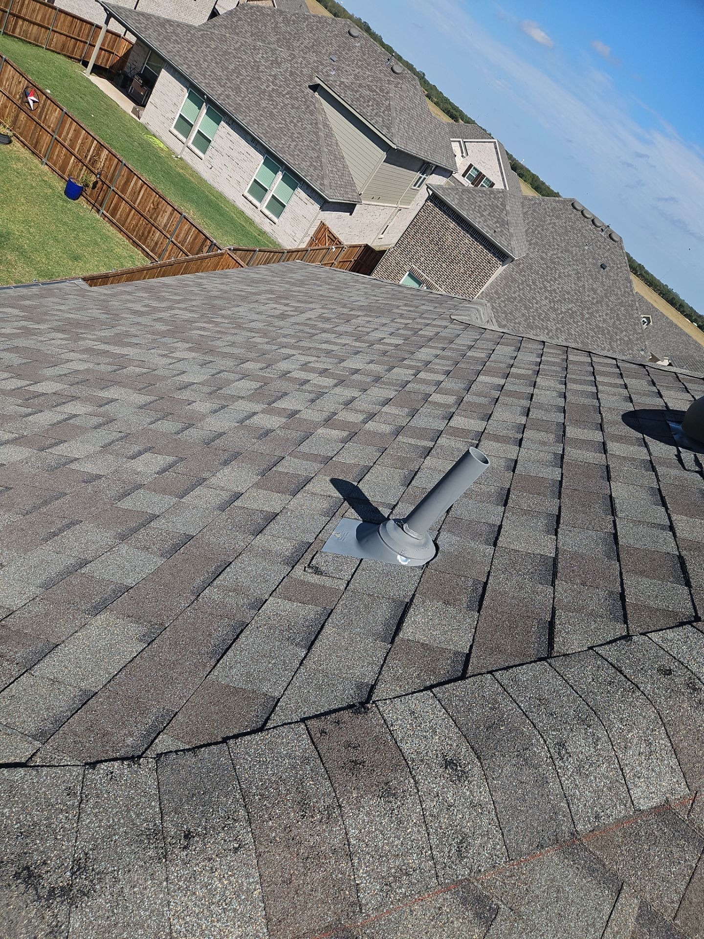 Hail impact marks on roof shingles before full roof replacement in Anna