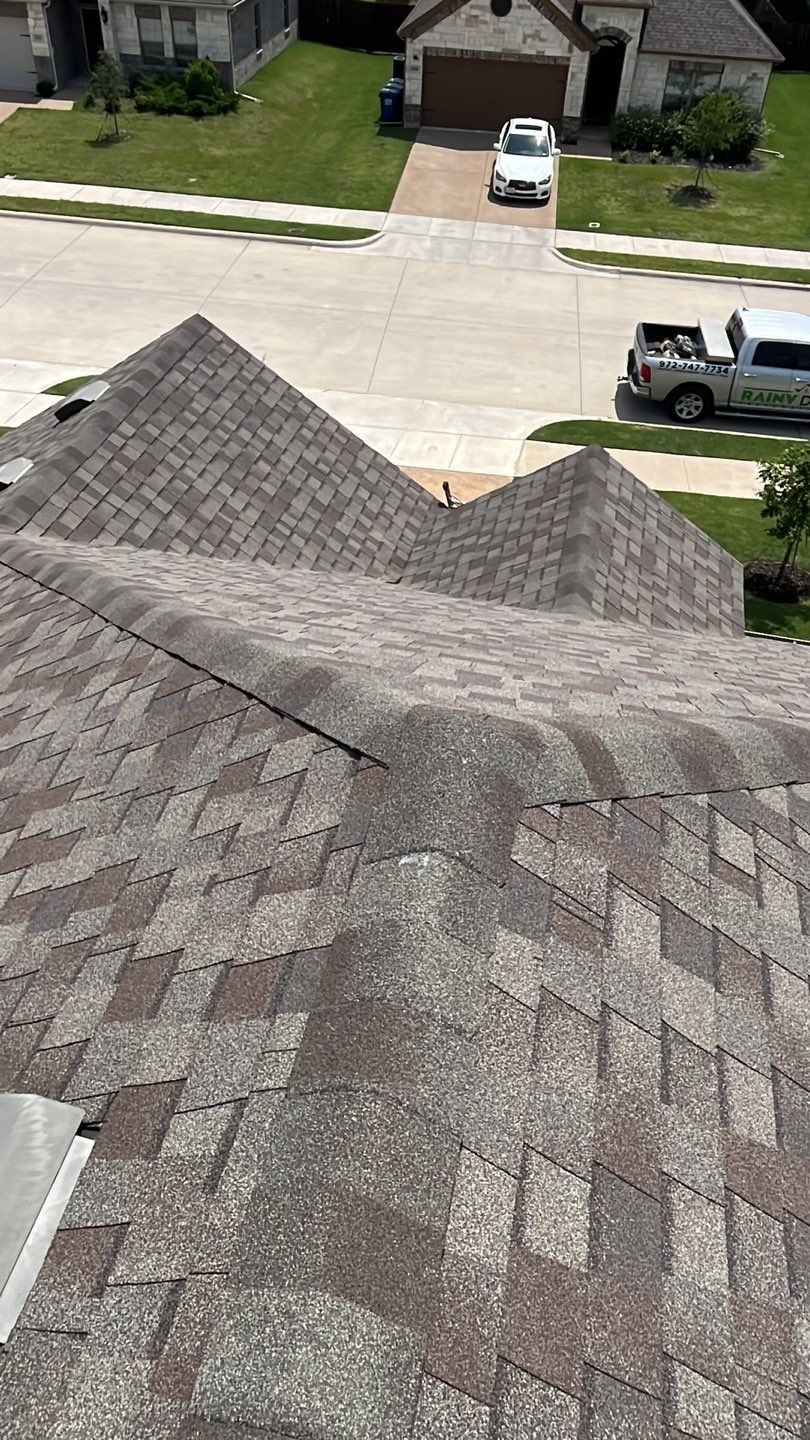 Gutter and downspout checked for granules during the roof inspection in Melissa, TX