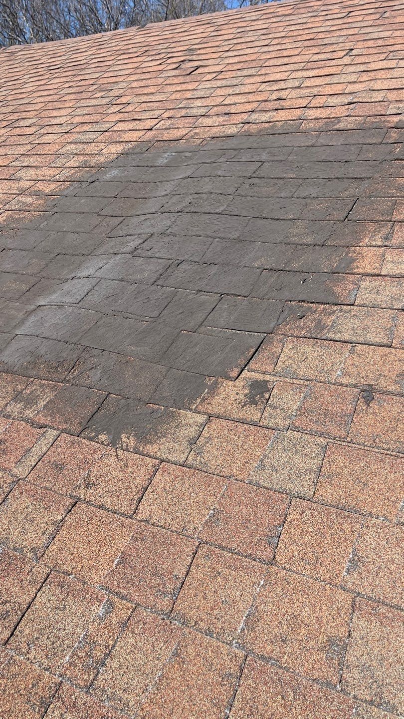 Worn shingle area with storm damage documented before the roof repair in Sherman, TX
