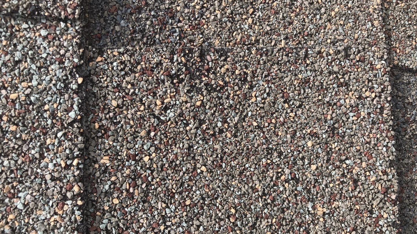 Widespread hail damage across the roof surface before the roof replacement in Melissa, TX
