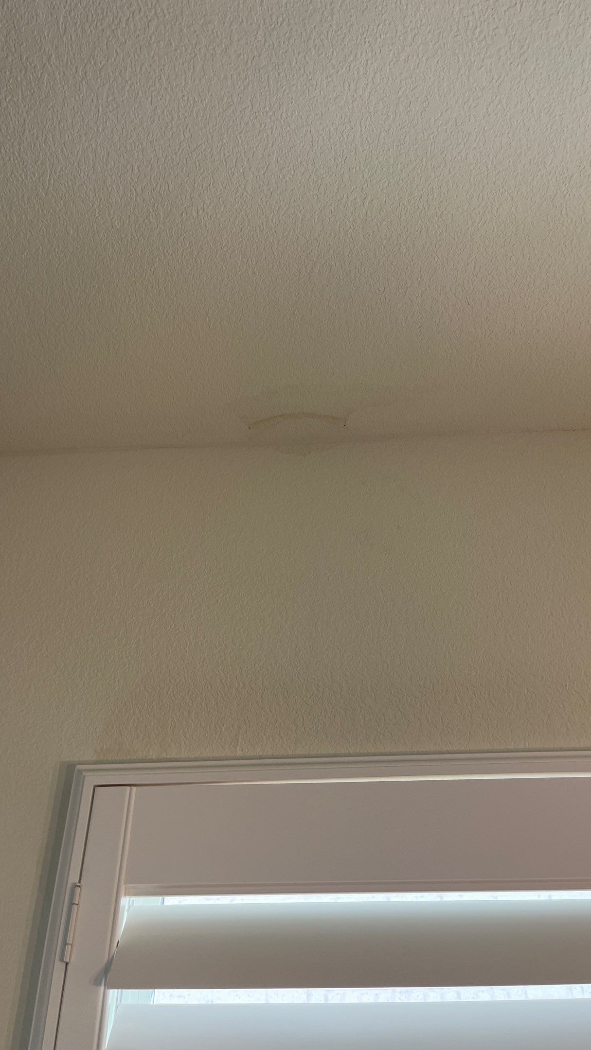 Moisture-damaged wall near the upstairs leak before restoration work in Frisco, TX