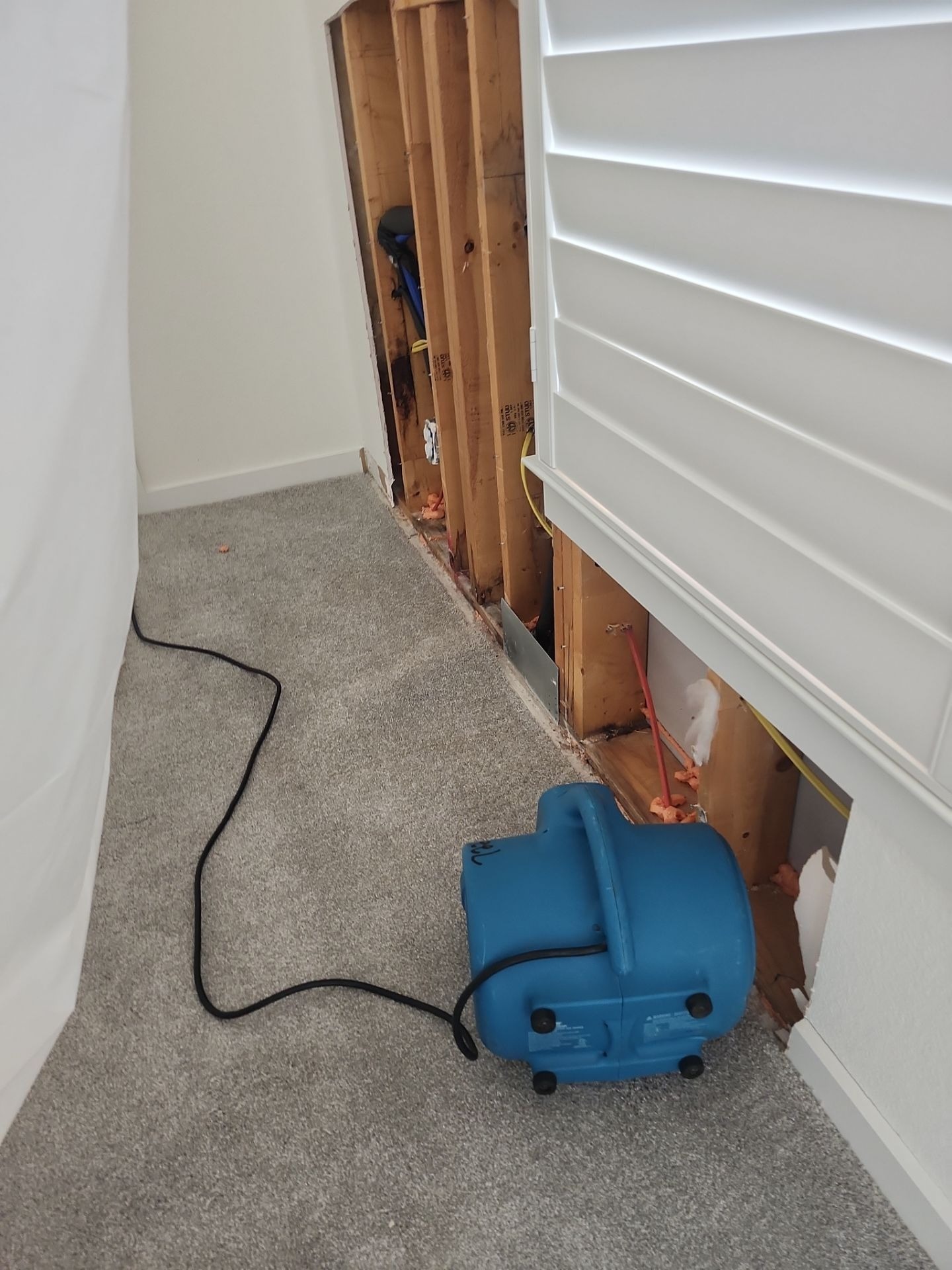 Flood cut removing wet drywall during water damage restoration in Frisco, TX