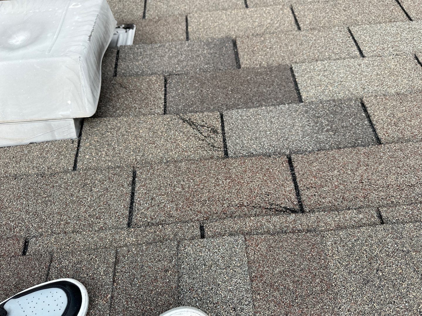 Close-up of hail-bruised 3-tab shingles found during the roof inspection in Anna, TX