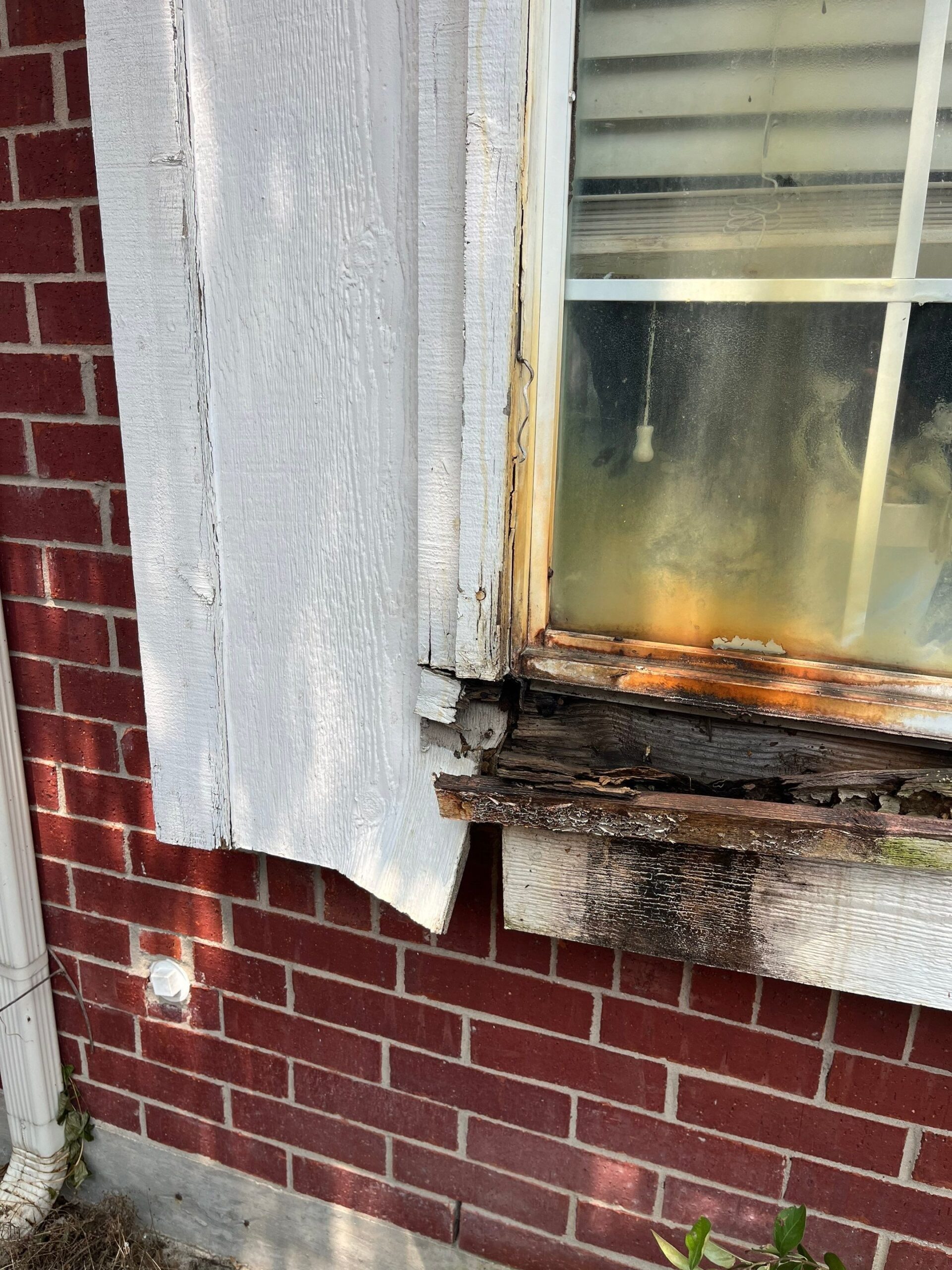 Deteriorated siding near box window before reconstruction in Allen, TX