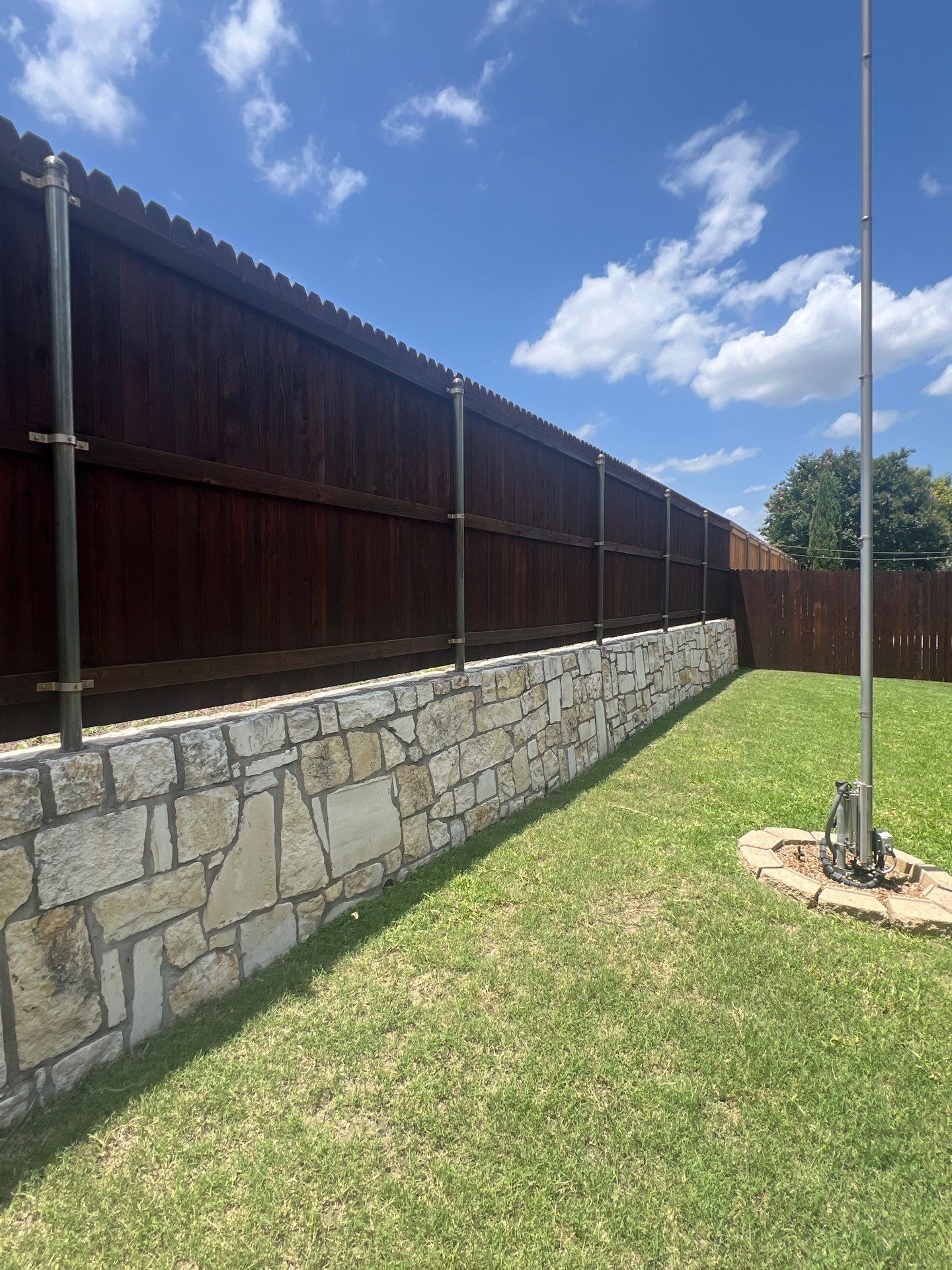Freshly stained fence finished alongside the roof replacement in Allen