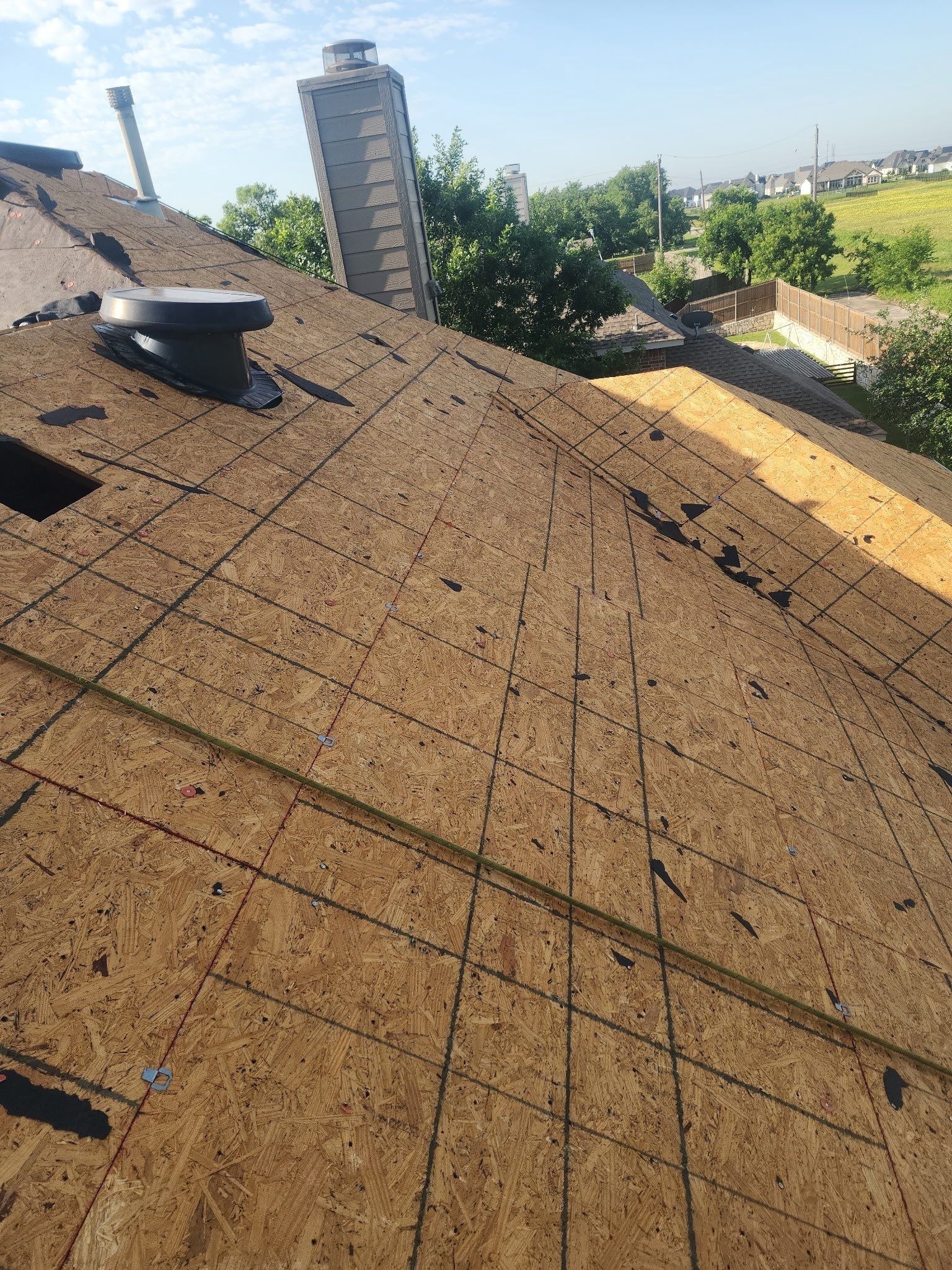 Roof deck exposed after full tear-off during the roof replacement in Allen, TX