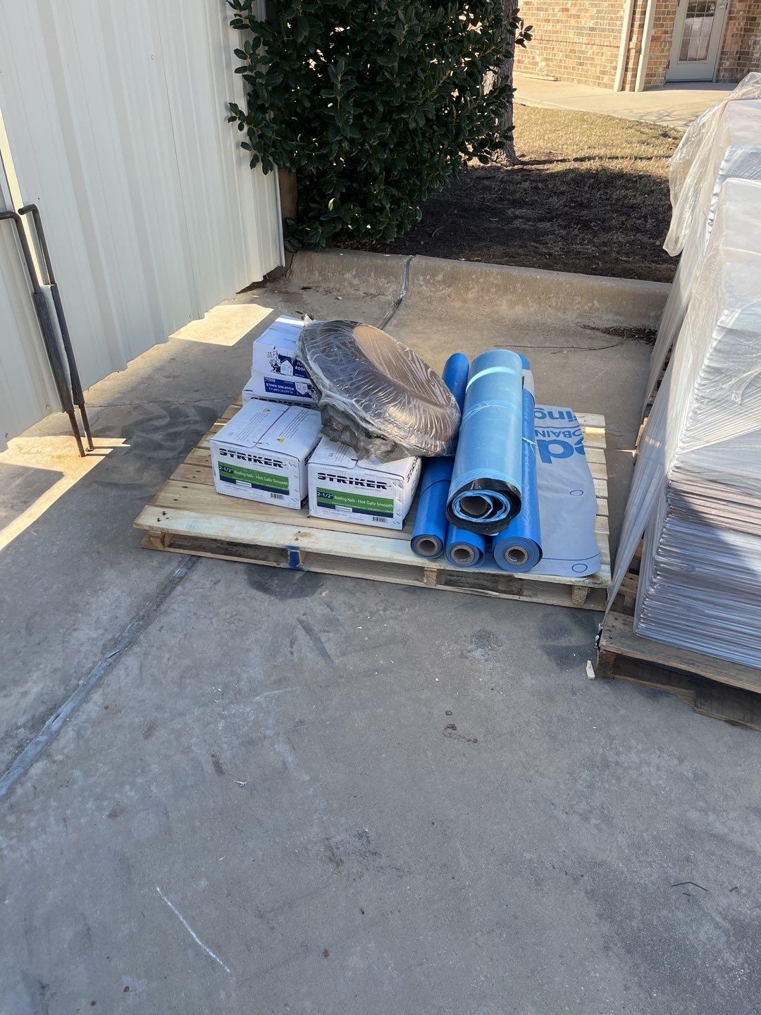 Pallets of custom-fabricated concrete tile staged during the roof replacement in McKinney, TX
