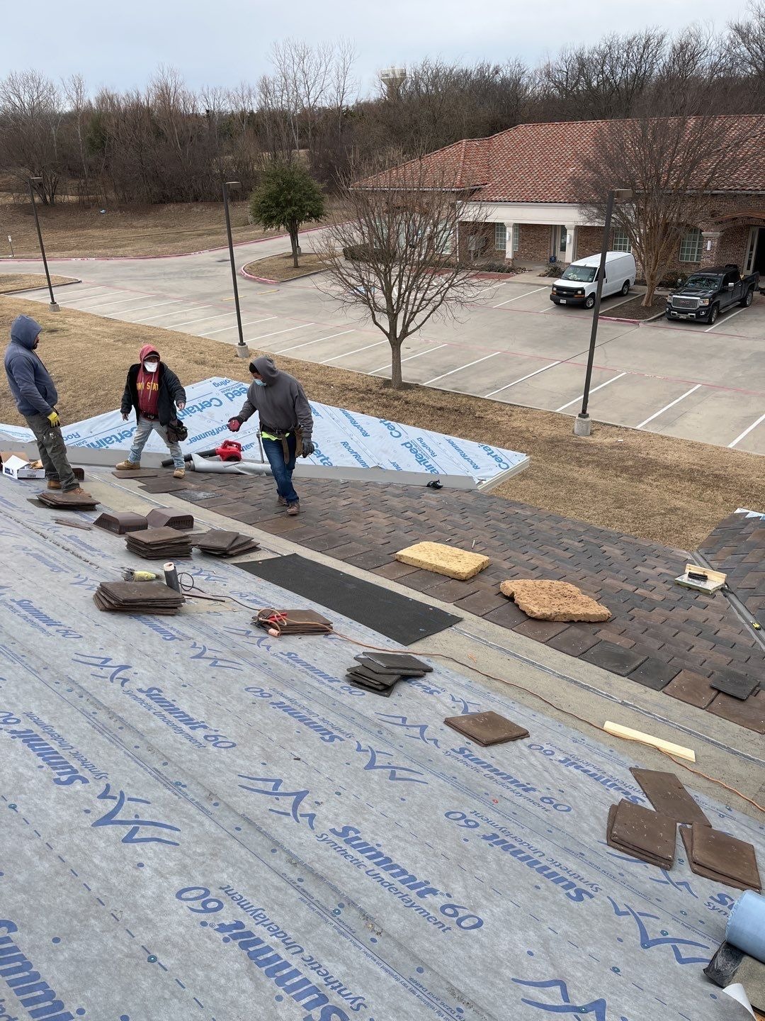 Partial tile installation in progress during the roof replacement in McKinney, TX