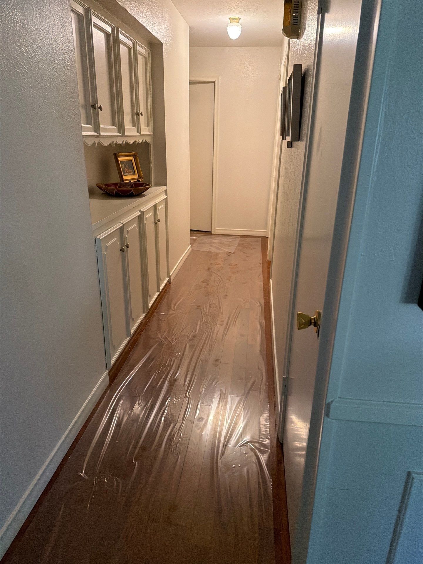 Plastic sheeting covering walkways to protect surfaces during crawl space moisture control in Dallas, TX