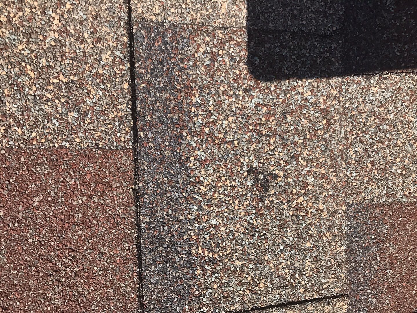 Hail damage visible on shingles before the roof replacement in Allen, TX