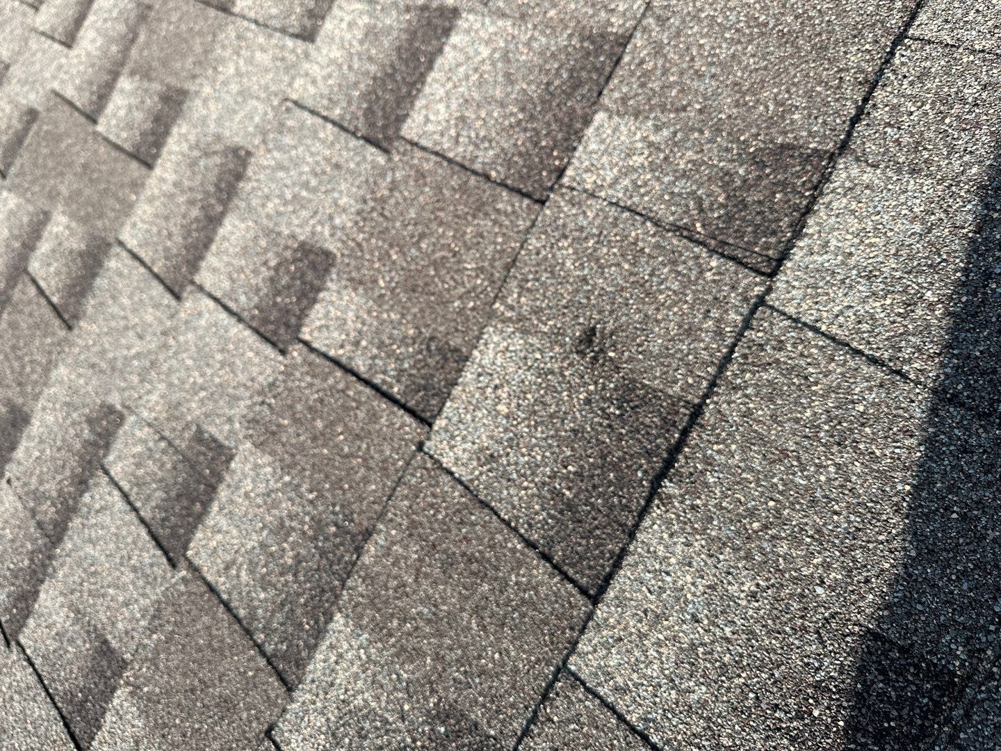 Wide view of the damaged roof before the roof replacement in Allen, TX