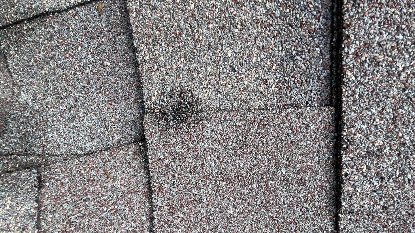 Wide view of storm-damaged roof slope before tear-off in Allen
