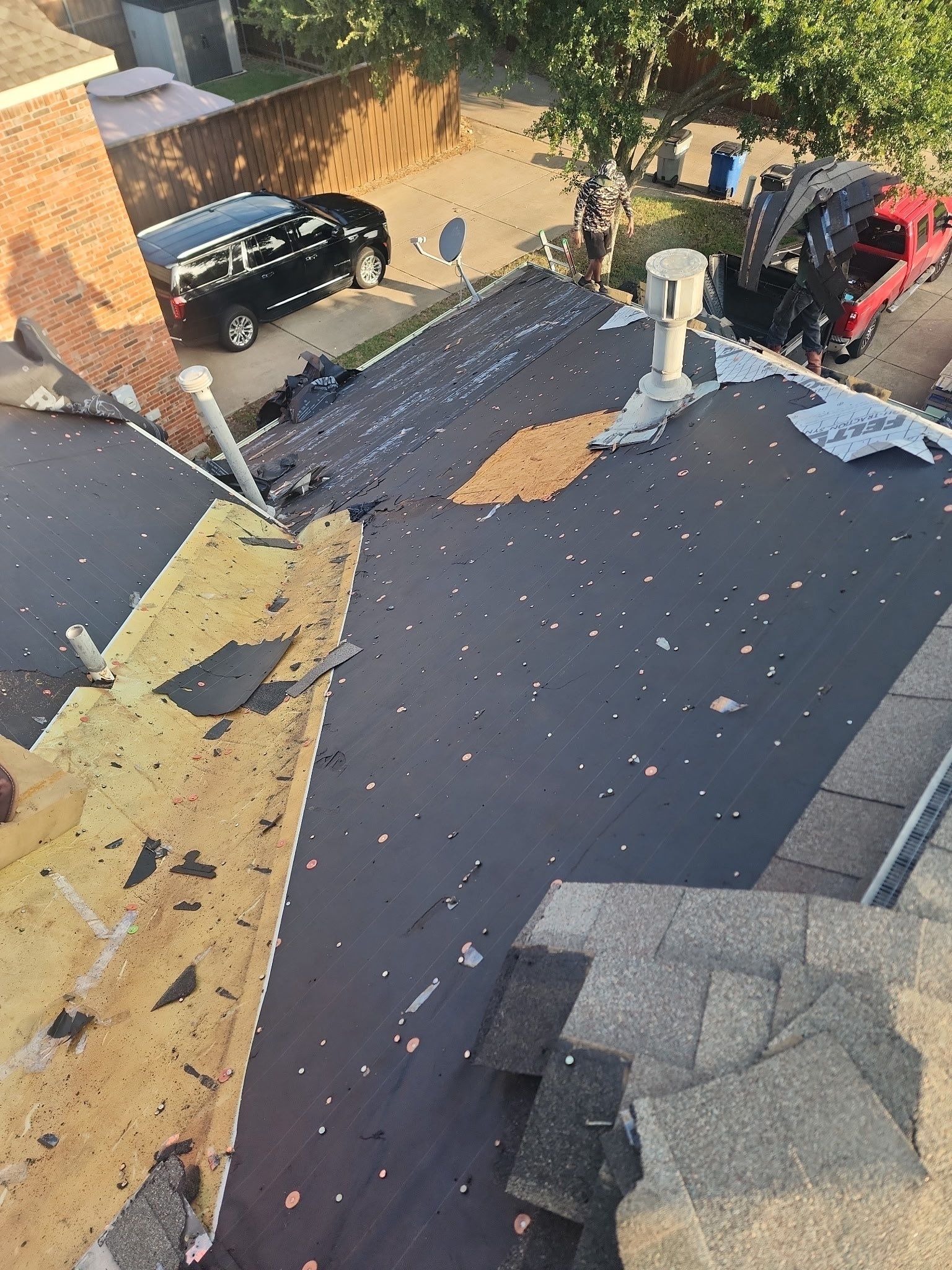 Multiple layers of old underlayment exposed during tear-off in Allen
