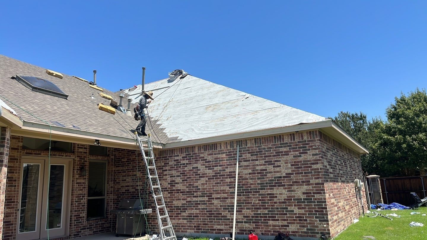New gutters being hung around the house during the roof replacement in Allen, TX