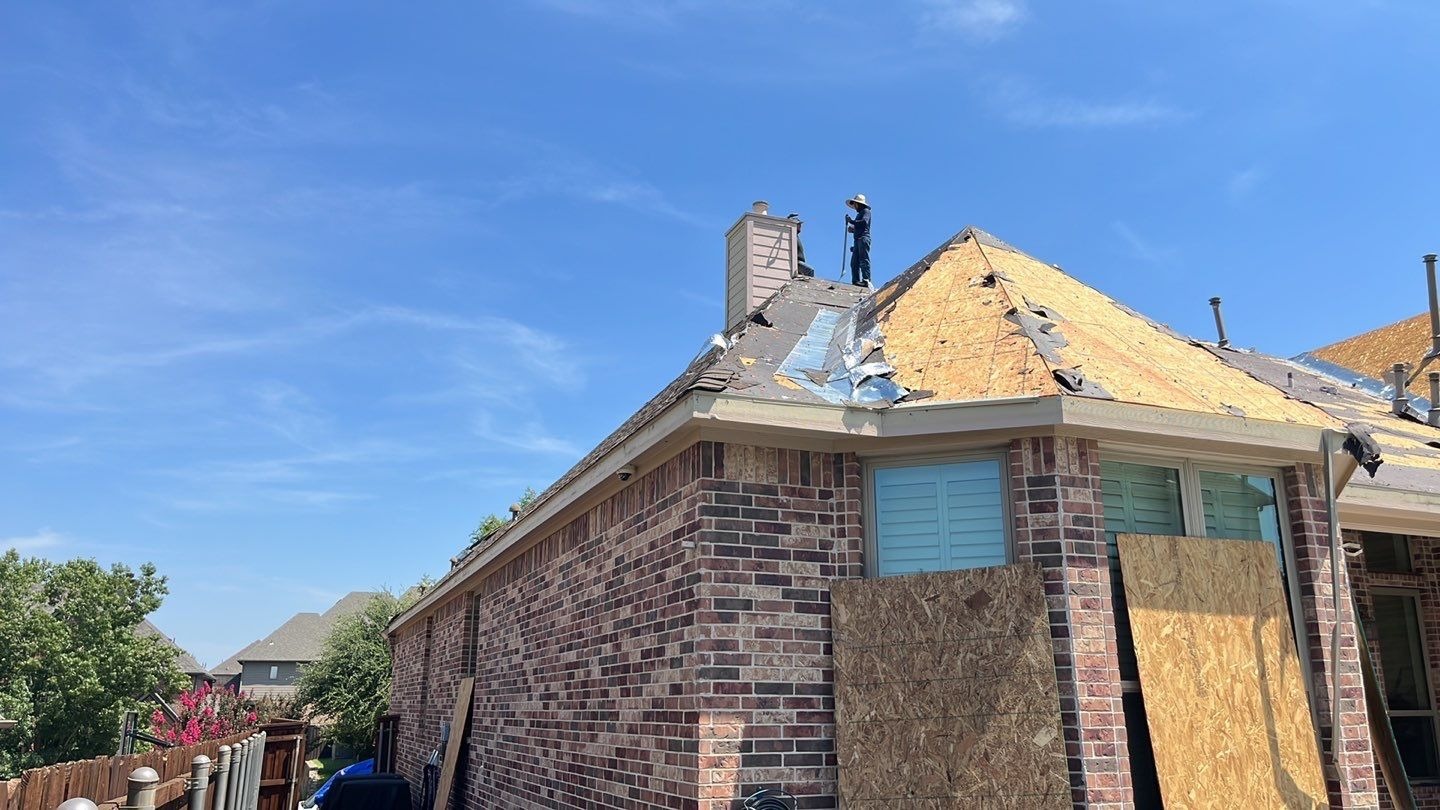 New ridge vent system being installed during the roof replacement in Allen, TX