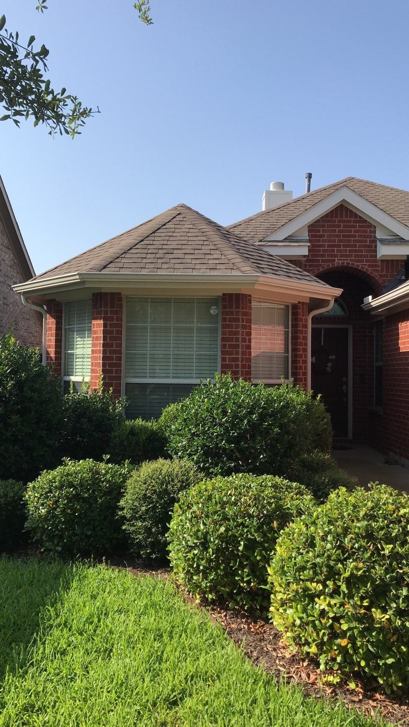 Hail bruising visible on shingles before the roof replacement in McKinney, TX