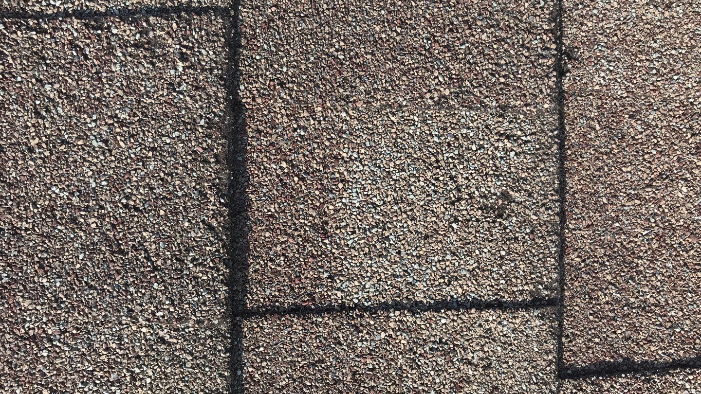 Lifted shingle edges documented before the roof replacement in McKinney, TX
