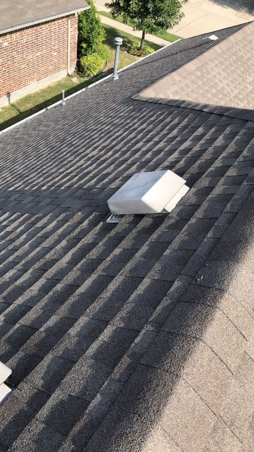 Wind-damaged shingle section found during inspection before the roof replacement in McKinney, TX