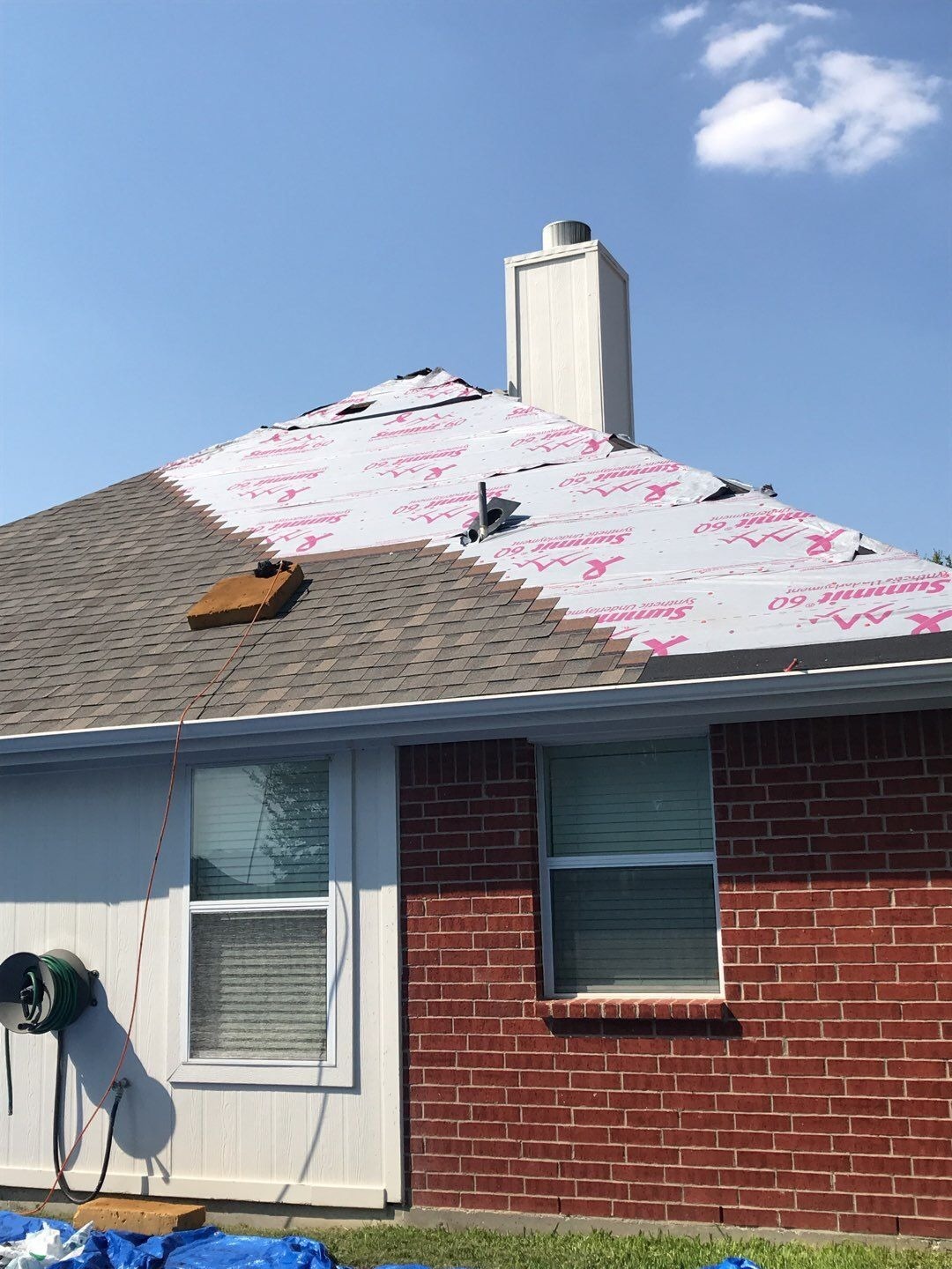 Crew installing new shingles during the roof replacement in McKinney, TX