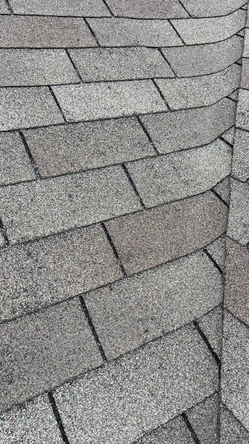 Leak staining visible on old 3-tab shingles before the roof replacement in McKinney, TX