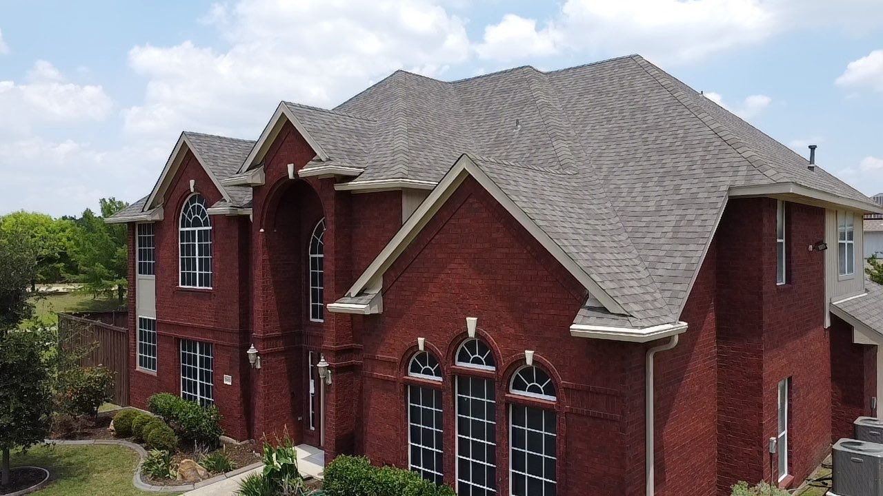 Final view of the completed roof replacement in McKinney, TX from the ground