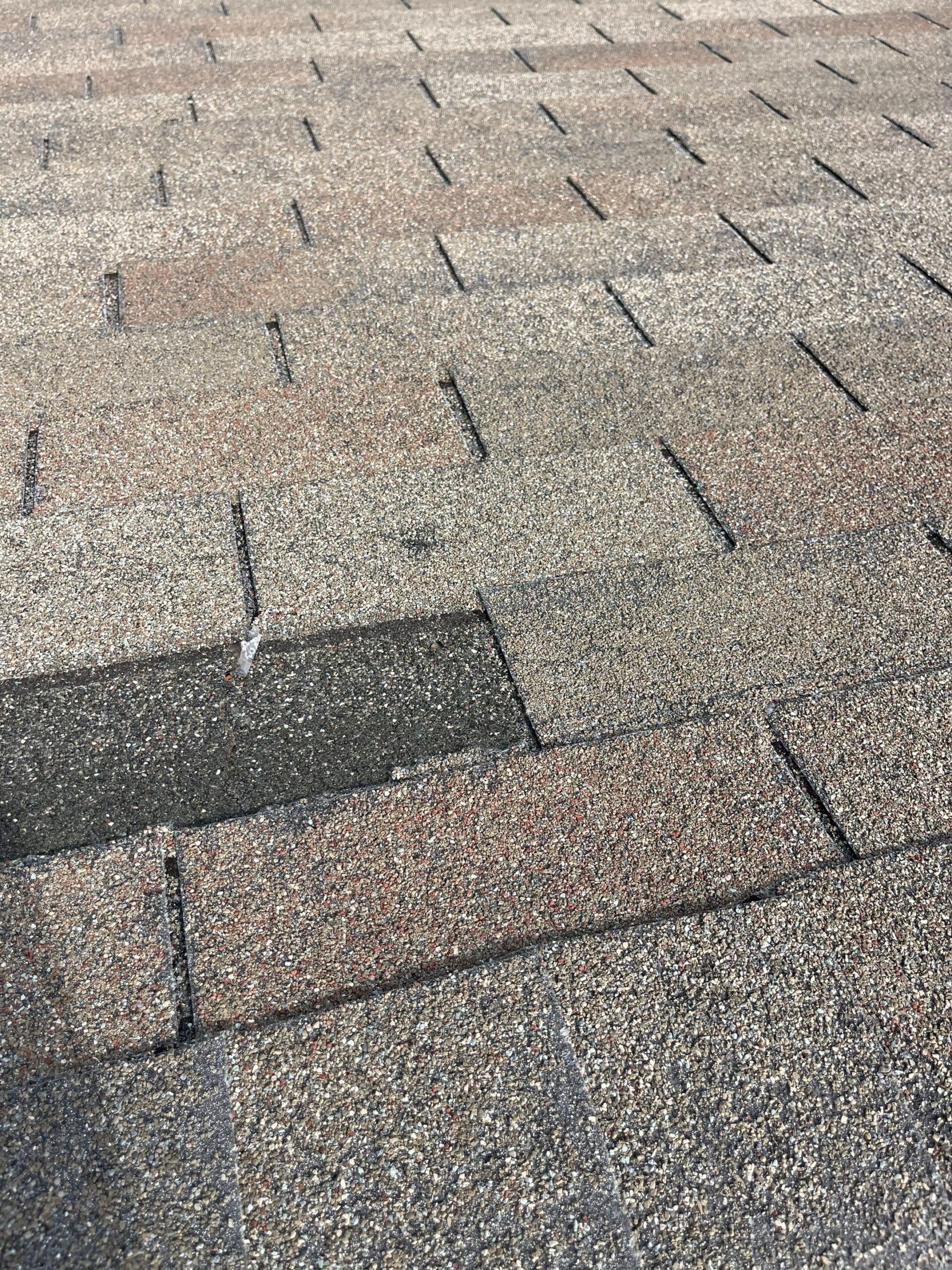 Wide view of storm-damaged roof slope before the Allen, TX roof replacement began