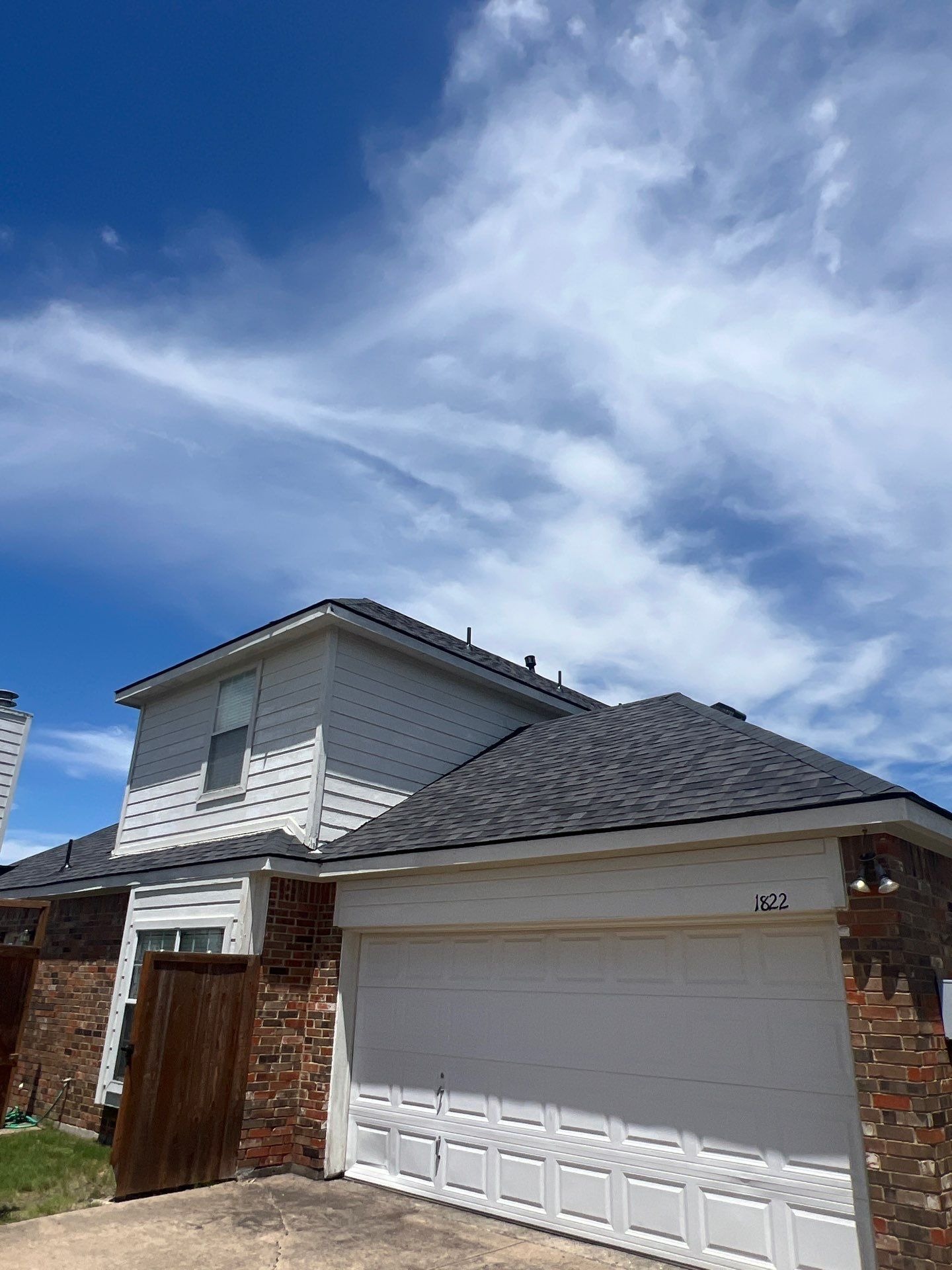 Crew installing new architectural shingles during the roof replacement in Allen, TX