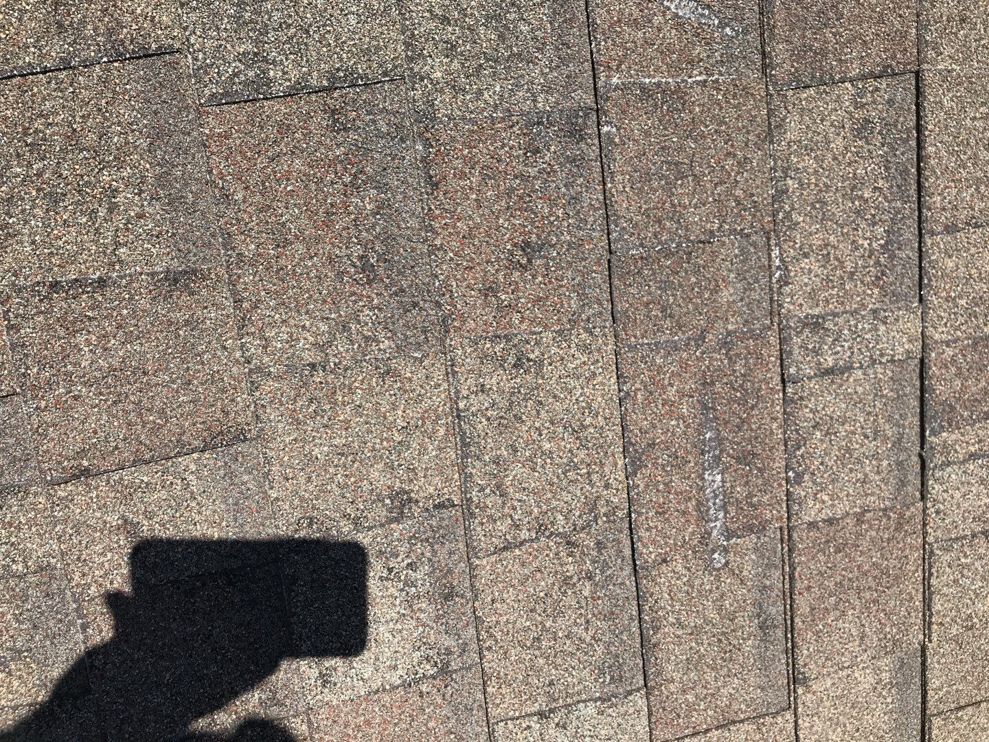Cracked shingle surface showing storm impact before the roof replacement in Allen, TX