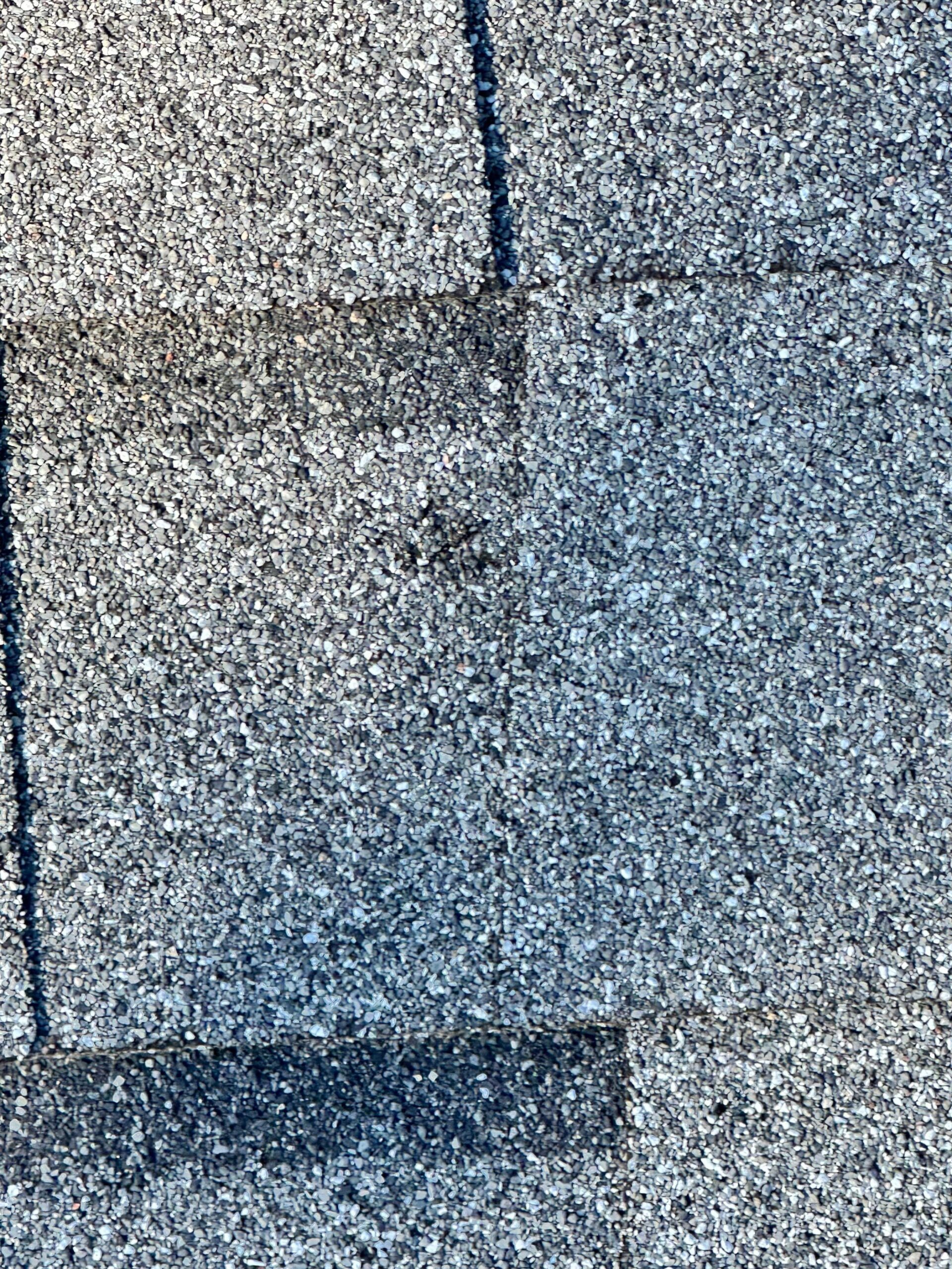 Hail-damaged shingles found on the roof before the roof replacement in Allen, TX