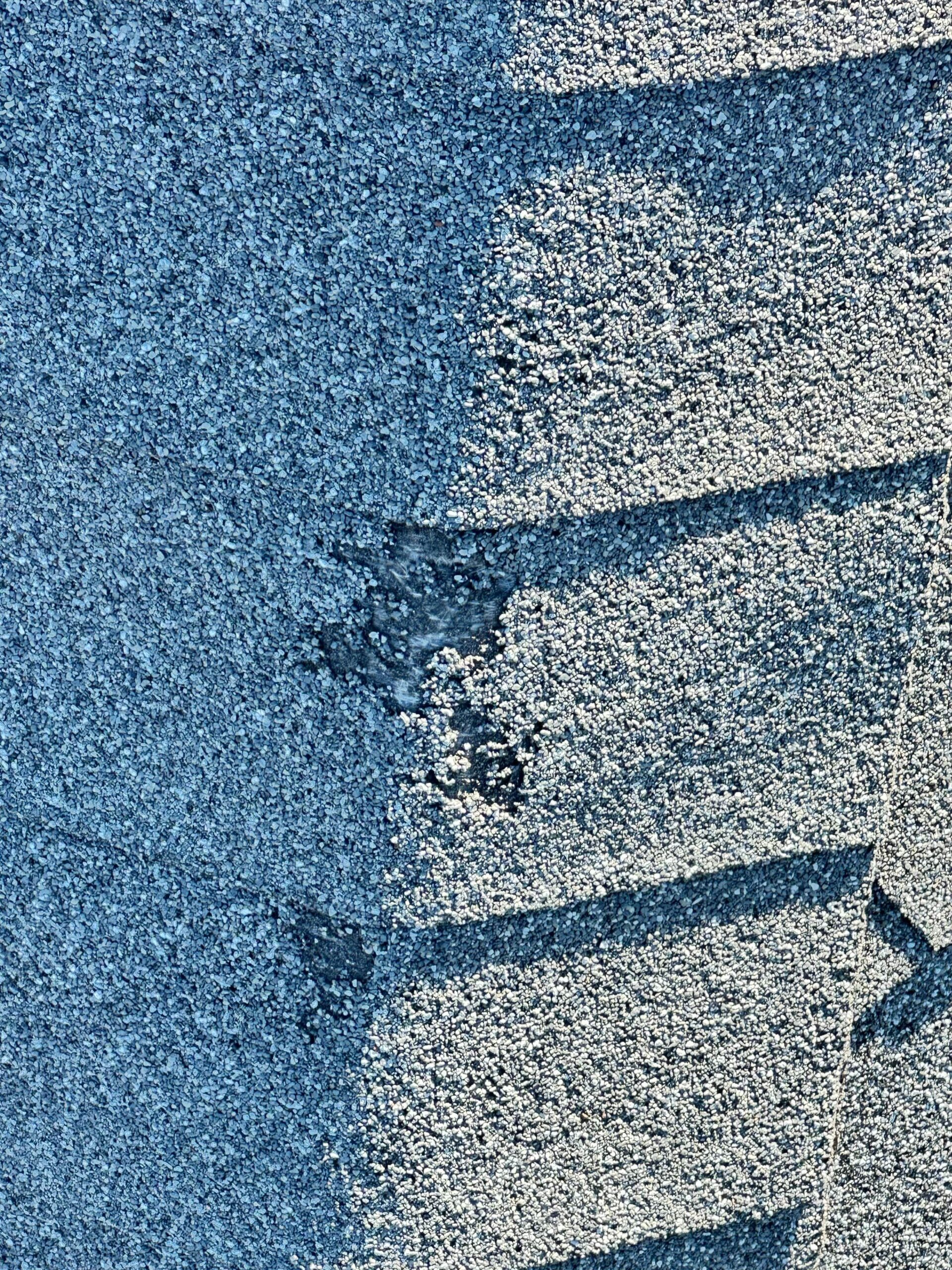 Wind-lifted shingle edges documented before the roof replacement in Allen, TX