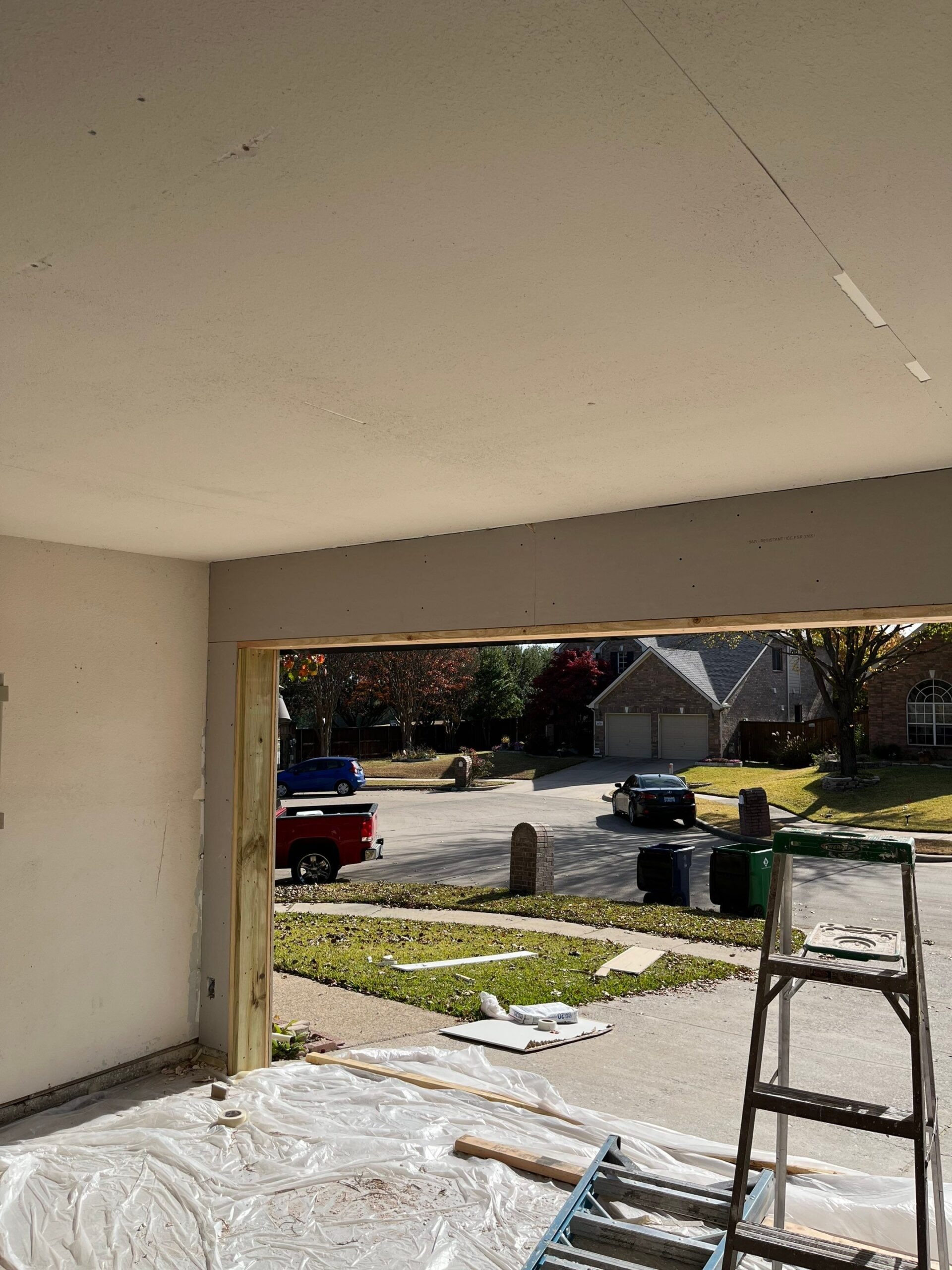 Matching brick being rebuilt above the garage during reconstruction in McKinney, TX