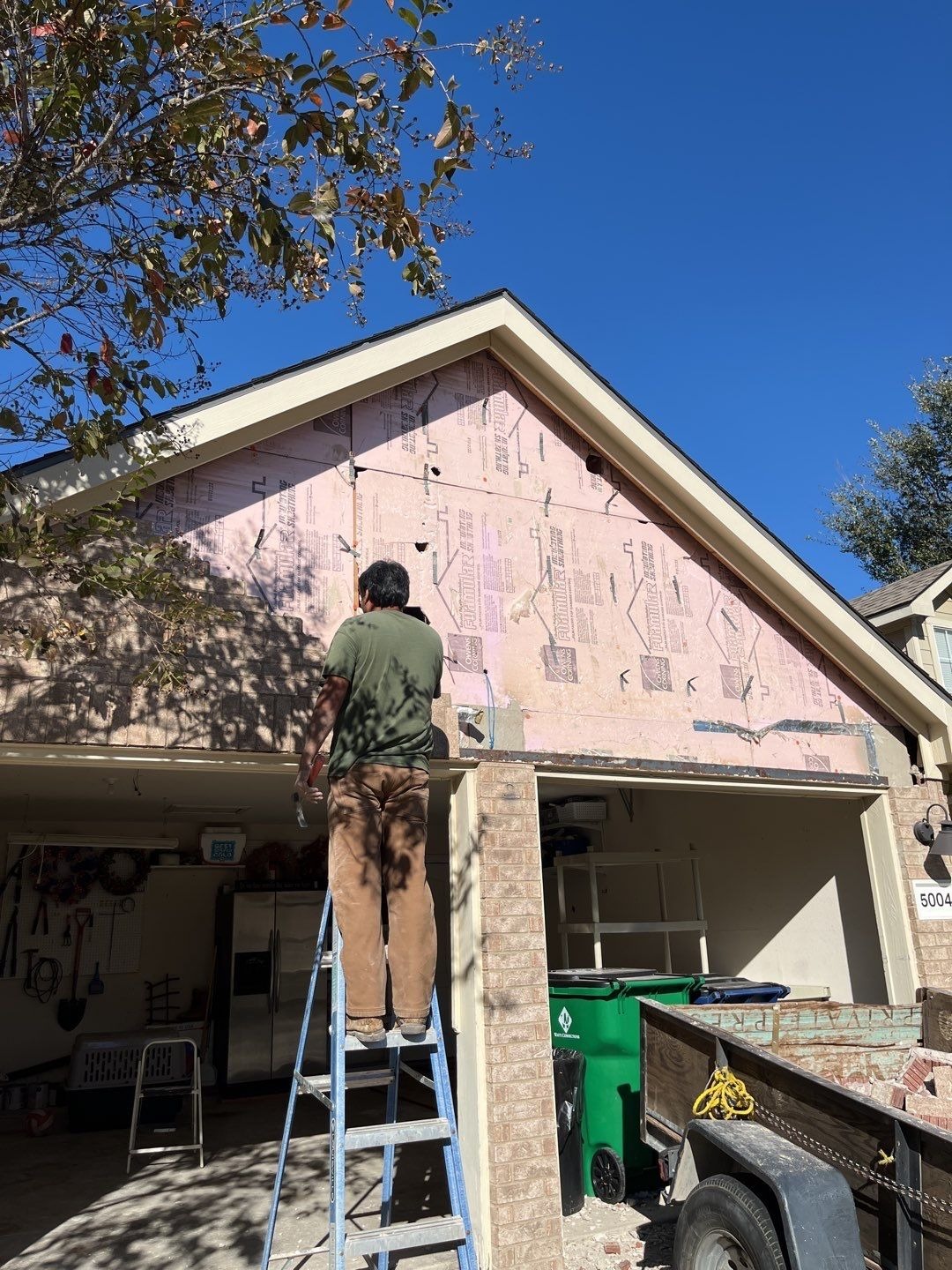 Brick removed above the garage opening during reconstruction in McKinney, TX