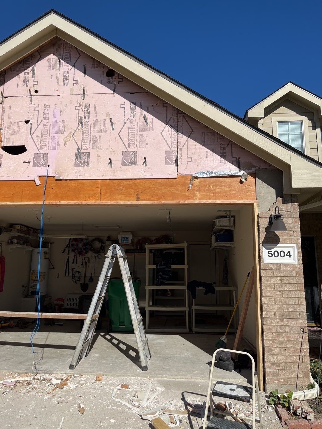 Header installation continuing above the widened opening in McKinney, TX